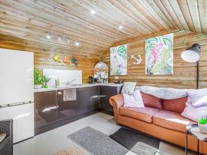 a living room with a couch and a kitchen at Dai Boy Cabin - Uk46403 in Cowbridge