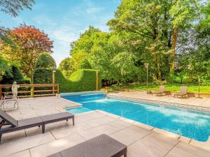 a swimming pool in a yard with chairs and trees at Dai Boy Cabin - Uk46403 in Cowbridge