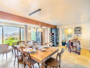 a dining room with a wooden table and chairs at Hillcrest Cottage in Stroud