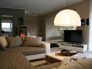 a living room with a couch and a flat screen tv at Lovely apartment near centre in Holzminden