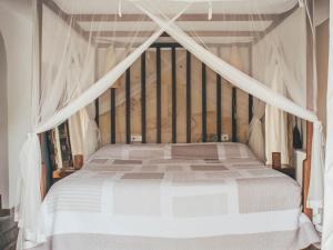 a bedroom with a white bed with a canopy at Beautiful holiday home with private pool in Cala Vadella