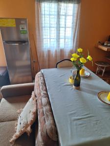 a table with a blue table cloth and flowers on it at Valsalms in Chaguanas