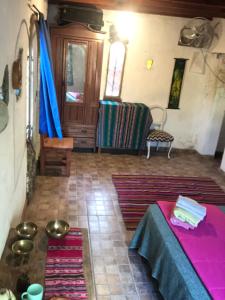 a living room with a table and some rugs at Sonqo Wasi in Cruz del Eje