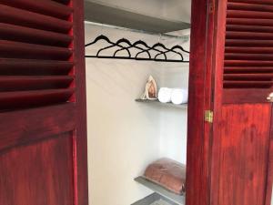 a closet with a red door and a shelf with towels at Depa doble centrico con Restaurante Terraza in Orizaba
