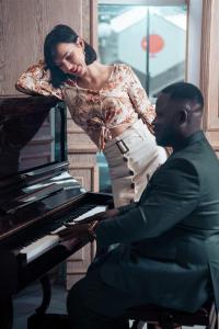 a woman sitting at a piano with a man at Oum Palace Hotel & Spa in Casablanca