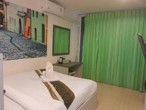 a room with a bed with a green curtain at Toto Residence in Ao Nang Beach