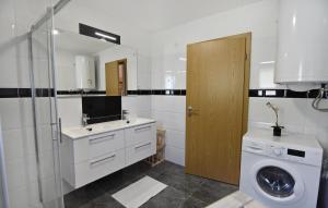 a bathroom with a sink and a washing machine at Family friendly house with a swimming pool Savudrija, Umag - 22399 in Savudrija +18 photos