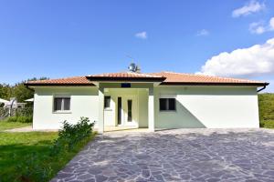 a white house with a red roof at Family friendly house with a swimming pool Buroli, Umag - 22400 in Umag