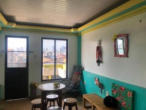 a room with a table and chairs and a window at Casa Belém in Belém