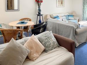 a living room with a couch and a table at Oak Cottage in Slapton