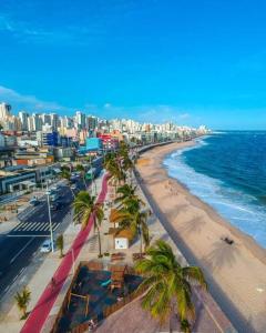 una vista aérea de una playa con palmeras y el océano en Flat Lindíssimo Beira-Mar, en Salvador