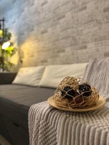 a wicker basket sitting on top of a bed at Cozy Hyve Soho Suites in Cyberjaya