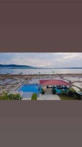 a view of a beach with a pavilion and the water at TOHO NIAS in Telukdalam