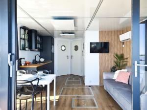 a living room with a couch and a table at Comfortable house on the water for 2 people in Łazy