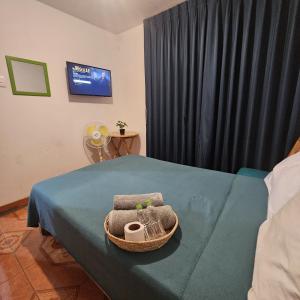 a room with a bed with a chair and a television at Lima Airport Hostel with FREE AIRPORT PICK UP in Lima