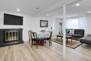 a living room with a table and a fireplace at Centered Home in West Springfield