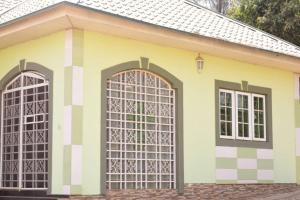 a yellow house with two doors at Royal Suites and Apartments in Jidu