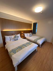 a hotel room with two beds in a room at CasaDel Beach House in Mabini