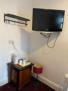 a flat screen tv hanging on the corner of a room at North Ocean Hotel in Blackpool