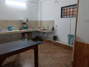 a kitchen with a counter and a table in a room at Bliss Villa 2 bedroom Apartment Marayoor - Reservation only after advance in Maraiyūr