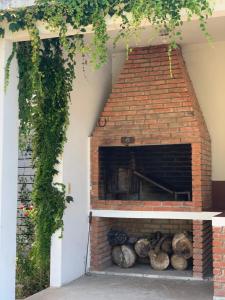 a brick oven with logs inside of it at Pucara del Este in Punta del Este