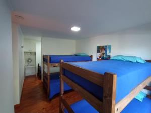 a bedroom with two bunk beds with blue sheets at Cabaña amoblada in Chillán