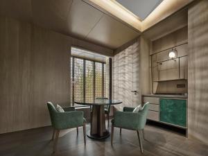 a dining room with a table and chairs at Banyan Tree Suzhou Shishan in Suzhou