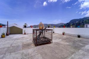 a bird cage sitting on top of a roof at Super OYO Collection O 81054 G Silver Srj Thaneesh Residency in Ooty