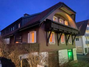 a house with a balcony on top of it at BohoStyleApartment am See in Schluchsee