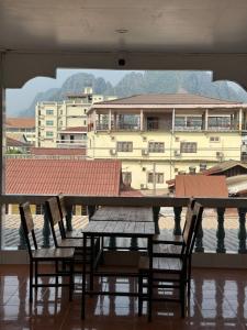 uma mesa e cadeiras com vista para um edifício em VangVieng Charming Boutique Hotel em Vang Vieng