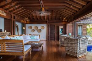 a living room with a white couch and wooden ceilings at Luxury Vacation Villa 6 in Pointe Milou