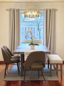 列治文山的住宿－Elegant Spacious 4BR House in Upscale Neighborhood，餐桌、椅子和窗户