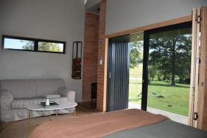 a bedroom with a bed and a couch and a table at Kileen Cottage in Nottingham Road