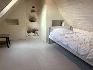 a bedroom with a bed in a room with a staircase at Maison avec WIFI, véranda, à 320m de la mer et à 500m de la plage, à Trégastel - FR-1-368-408 in Trégastel