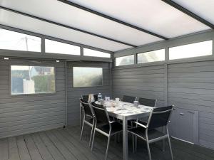 a dining room with a table and chairs on a deck at Maison avec WIFI, véranda, à 320m de la mer et à 500m de la plage, à Trégastel - FR-1-368-408 in Trégastel +11 photos