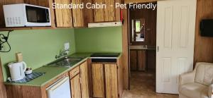 a kitchen with a sink and a microwave at River Retreat Home & Holiday Park in Tweed Heads +19 photos