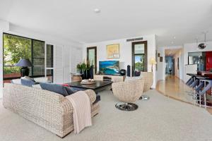 a living room with a couch and chairs and a table at Laidback luxury living, Noosa Heads in Noosa Heads