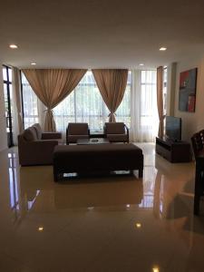 a large living room with a couch and a television at Samsuria Private Beach Front in Kuantan
