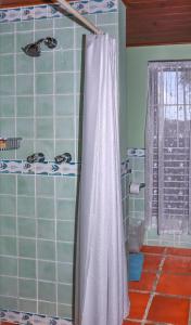 a bathroom with a shower with a white shower curtain at Calypso Court - Private 1 bedroom villa with pool villa in Cap Estate +26 photos