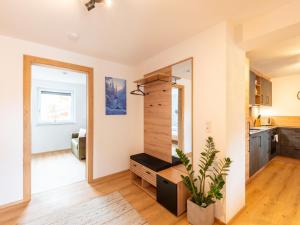 a kitchen and living room with a plant at Thunhaus Apartments with ski-storage in Uderns