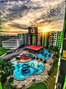 an overhead view of a resort with a swimming pool at One Life Four Season Waterpark Guest House Manhattan Condominium in Ipoh