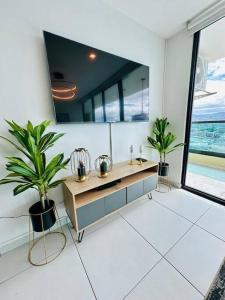 a bathroom with two potted plants and a mirror at Luxury 1BR Apartment in Astria 706 in Tegucigalpa