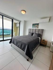a bedroom with a bed with a view of the ocean at Luxury 1BR Apartment in Astria 706 in Tegucigalpa