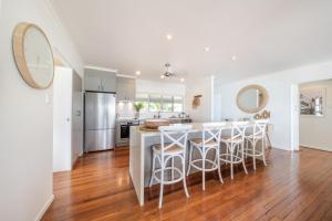 a kitchen with a large island with bar stools at A Point of View in Airlie Beach