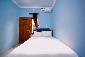 Ένα ή περισσότερα κρεβάτια σε δωμάτιο στο Bayang Brothers Residence By Occupied