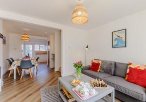 a living room with a couch and a table at By The Bay in Westgate-on-Sea