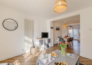 a living room with a table and a dining room at By The Bay in Westgate-on-Sea