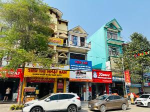 a city street with cars parked in front of buildings at Huong Thao Hostel & Tours in Dien Bien Phu