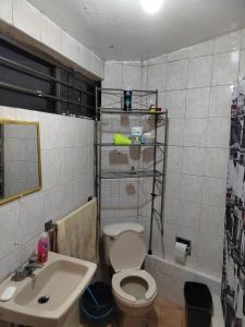y baño con aseo y lavamanos. en Departamento de huéspedes Grijalva, en Ciudad de México