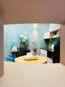 a kitchen with a table with flowers on it at DORI HOUSE NTL in Ho Chi Minh City